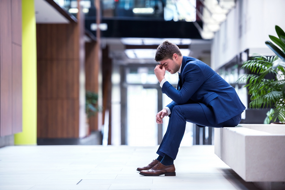 leadership myth holding a manager back in a blue suit