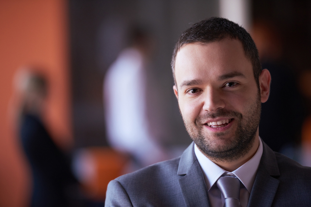 happy young business man portrait  at modern meeting office indoors