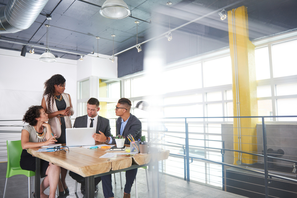 team of successful business people having a meeting in executive sunlit office-1